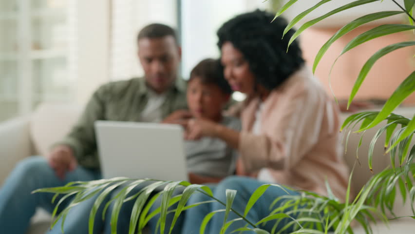 Happy family African American parents mum dad and Caucasian little boy kid child teenager son use laptop playing video game together watch fun cartoons win bet online victory celebrate on sofa at home Royalty-Free Stock Footage #1108206035