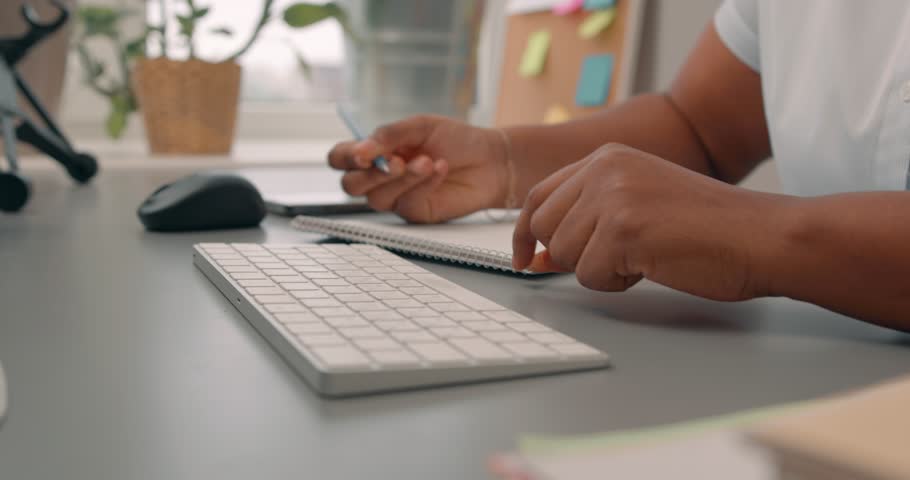 black woman's hands typing on a laptop keyboard. student making notes, girl sitting on chair working online, getting education, studing Slow motion, girl taking part in vebinar, session