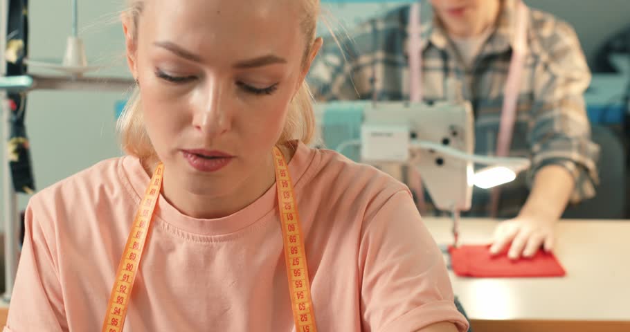 process of creating fashionable clothes , outfit. attractive young woman seamstress sitting and sews on sewing machine in studio girl learning to repair a garment, sewing techniques for beginners Royalty-Free Stock Footage #1108212659