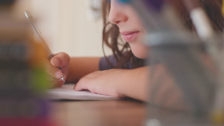 child writes in a notebook at the lesson. Children's hand close-up. the child uses a pencil to practice writing letters. The child learns to write in a notebook. preschool education concept. - Powered by Shutterstock - Get 15% off with code: PIKWIZARD15