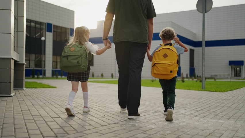 Happy Father Holding Hands Of His Little Son And Daughter, Walking In School Yard In Morning Royalty-Free Stock Footage #1108213865