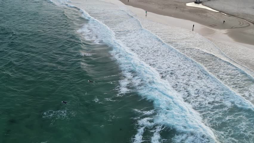 Surfers enjoying the sunset at Maroubra Beach, Sydney, New South Wales, Australia.