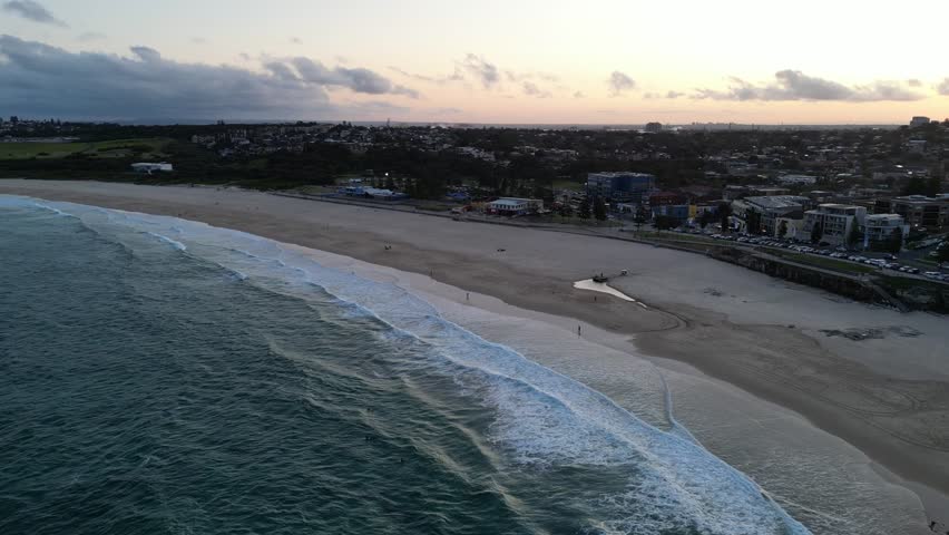 Surfers enjoying the sunset at Maroubra Beach, Sydney, New South Wales, Australia.