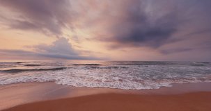 Ocean coast and scenic sunrise over sea waves and beach, 4K slow motion video