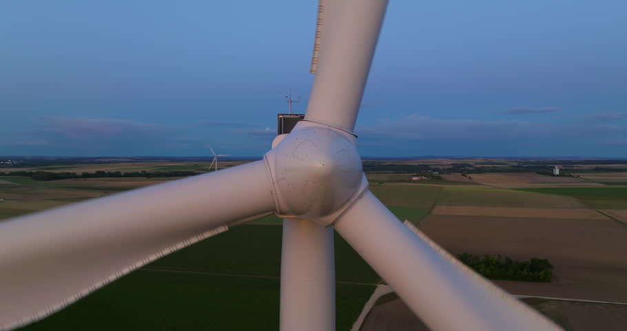 Wind turbine, aerial view. Wind farms in the field, rotating blades, alternative renewable energy sources. Green and renewable energy concept