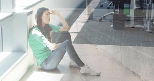 Animation of people walking over tired caucasian businesswoman sitting on floor in office. Business, stress and workplace concept digitally generated video.