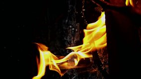 Fire in super slow motion, fire flares seen in super slow motion up close, natural light, 4k. vertical video