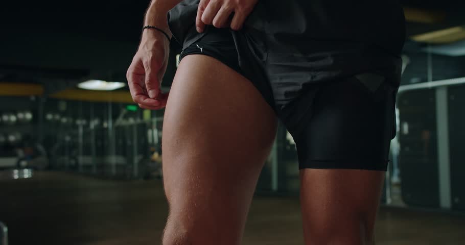 Cropped view on strong bodybuilder male demonstrate quadriceps muscles. Athletic sportsman training legs and body in gym. Fitness and bodybuilding concept Royalty-Free Stock Footage #1108232865