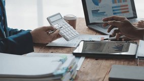 Financial analysts analyze business financial reports on a digital tablet planning investment project during a discussion at a meeting of corporate showing the results of their successful teamwork. - Powered by Shutterstock - Get 15% off with code: PIKWIZARD15