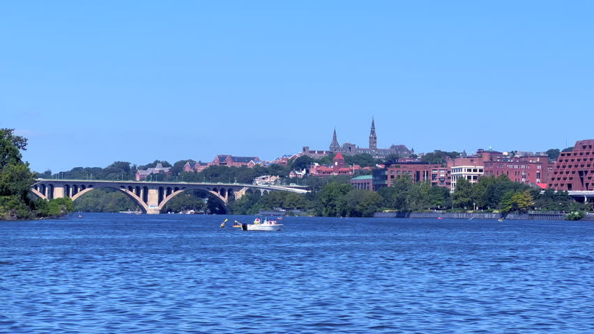 Georgetown, Washington DC. View of the Potomac River. View of Key Bridge  and Georgetown University. Boat and canoes. Royalty-Free Stock Footage #1108237869