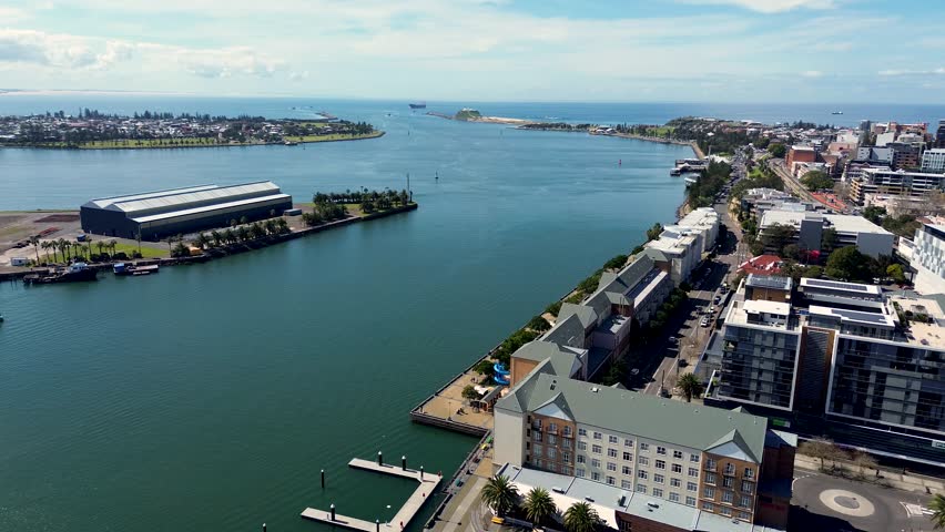 Drone aerial shot of Hunter River channel inlet Newcastle harbour Honeysuckle wharf Stockton Carrington NSW CBD travel tourism coal Australia 4K