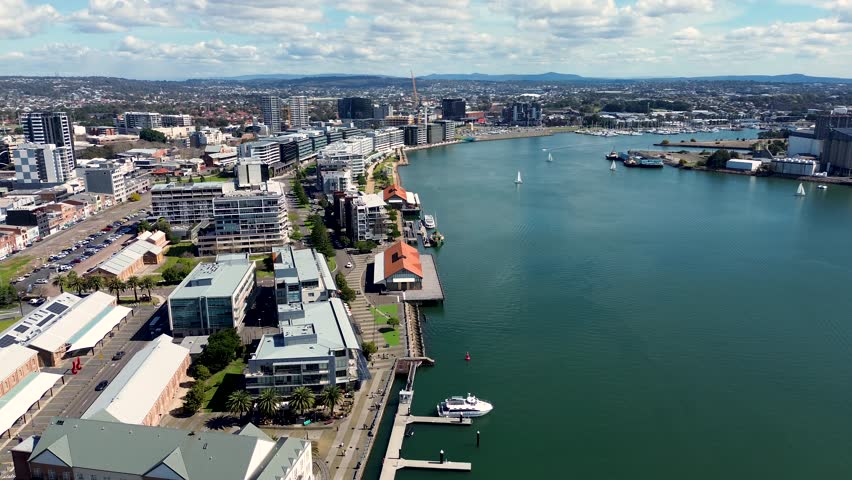 Drone aerial shot of Honeysuckle Newcastle Harbour urban commercial buildings channel travel tourism NSW Australia 4K