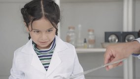 Indian students child and teachers in a science classroom are thrilled by the smoke produced by die ice reacting with water. Blowing smoke and having fun. - Powered by Shutterstock - Get 15% off with code: PIKWIZARD15