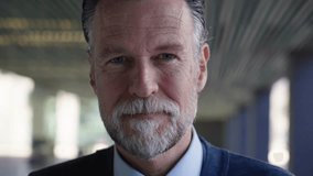 Close up portrait of middle aged Caucasian attractive grizzled business man confident expression. Senior male in formal wear looking smiling to camera outdoor. Successful boss blurred background. - Powered by Shutterstock - Get 15% off with code: PIKWIZARD15