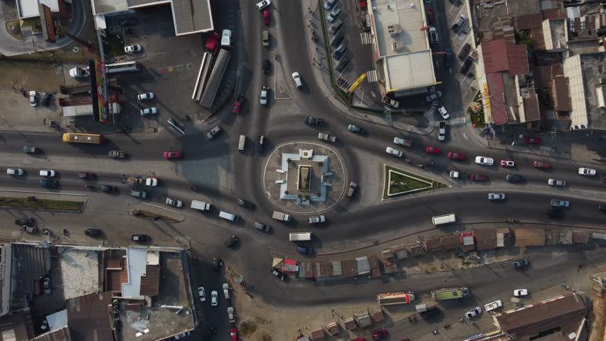 Aerial timelapse descends to vehicles driving around traffic circle Royalty-Free Stock Footage #1108241383