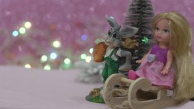 doll on a toy sled,Christmas background, a bunny with a doll and a sleigh next to a Christmas tree - Powered by Shutterstock - Get 15% off with code: PIKWIZARD15