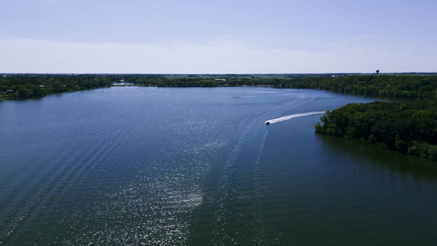 A Drone Flying Over a Speed Boat Boating Across Killarney Turtle Mountain Lake During the Summer in South West Manitoba Canada
