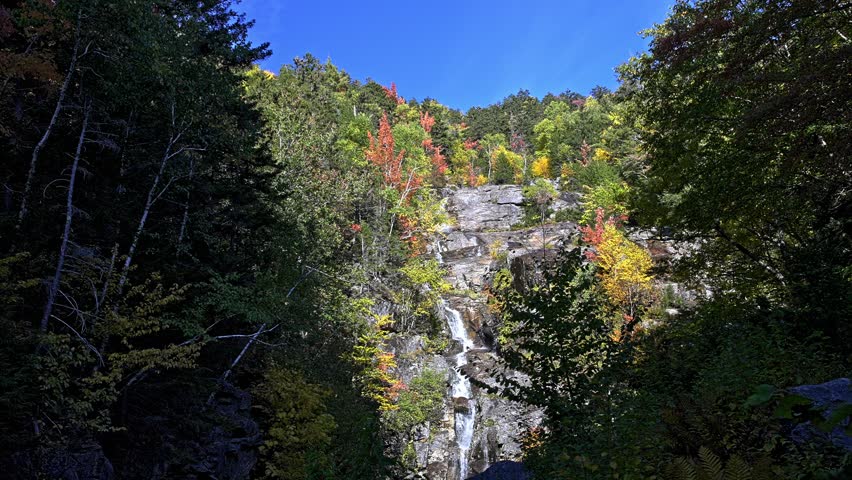 Waterfall in New Hampshire with colorful autumn colored forest