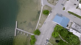 Dock and beach of Lake Missaukee in Lake City, Michigan with drone video overhead looking down.