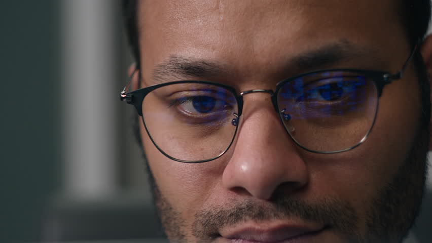 Close up concentrated entrepreneur work online with computer data male eyes in eyeglasses looking laptop monitor businessman busy with business information man look screen light reflection in glasses Royalty-Free Stock Footage #1108254491