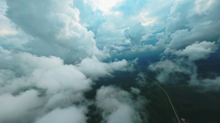  The drone flies through the clouds and flies to the ground at a great height. Aerial 4K Royalty-Free Stock Footage #1108256515