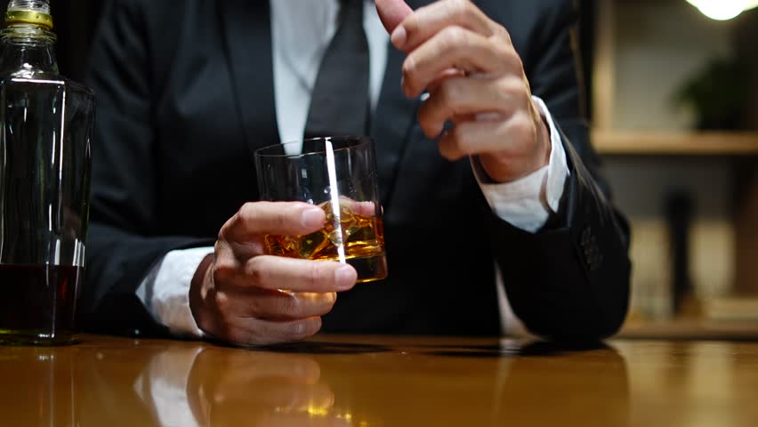 Businessmen in suits drinking whiskey