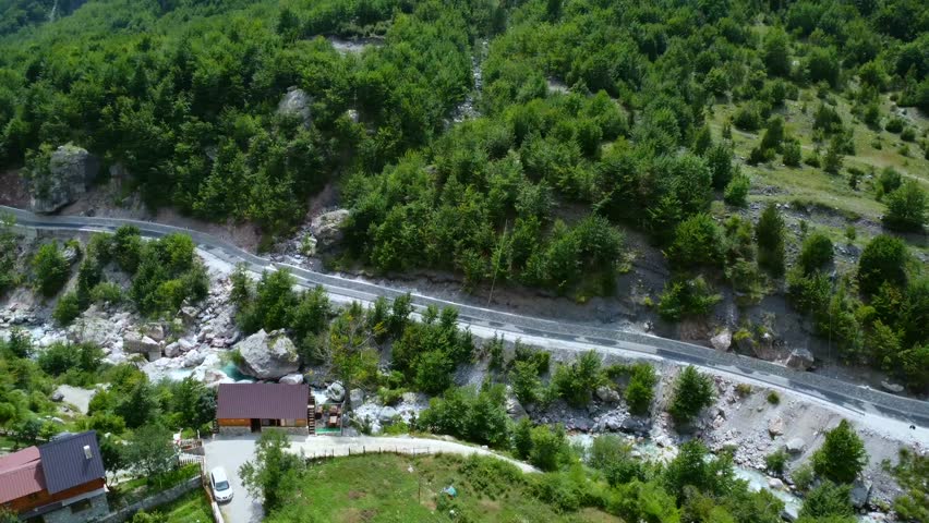 Aerial shot over the waterfall river in Theth National Park, Albania