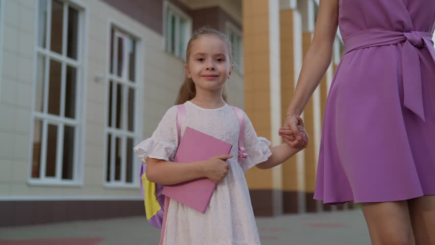 greatest happiness life seeing child smile light up mother face carry backpack filled textbooks, ready return school work teams. laughter and joy bring family testament strong bond between mom child