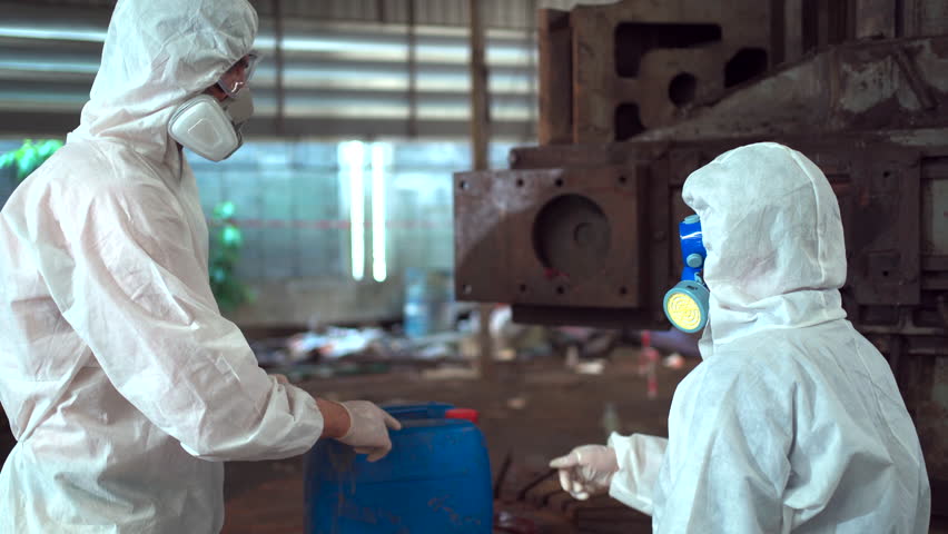 Team of scientist wearing a chemical protection suit and high efficiency filter face mask working in the bio - chemical contaminated factory. Bio chemical scientists working in the hazardous area. Royalty-Free Stock Footage #1108270721