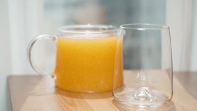 I pour orange juice with pulp from the pitcher into the glass, in slow motion. - Powered by Shutterstock - Get 15% off with code: PIKWIZARD15