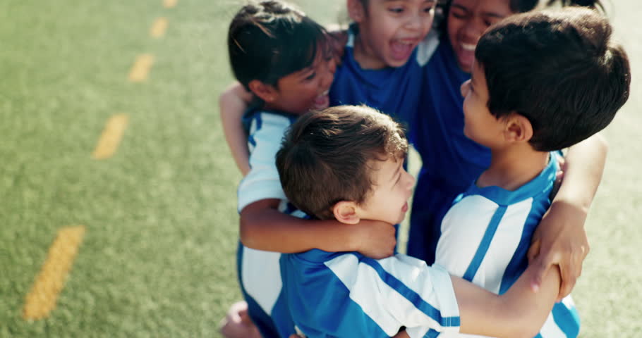 Hug, above and children on a field for soccer success, celebration or excited about a goal. Smile, group and kids with a huddle or win with teamwork, fitness or achievement together in football Royalty-Free Stock Footage #1108281827