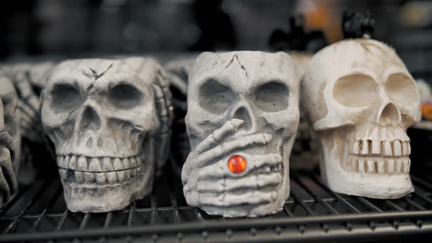  Halloween. skull candlesticks. close-up. ceramic figurines of skulls on a shelf in a store. Halloween accessories. decorations for Halloween. preparations for Halloween.  Royalty-Free Stock Footage #1108282463