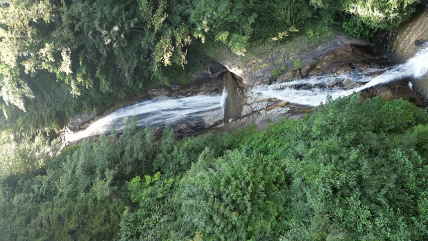 Rize manle waterfall. Aerial view of beautiful waterfall in green forest. Natural waterfall flowing from the Black Sea mountains. Drone view. Rize Turkey. vertical shot waterfall image. Story format