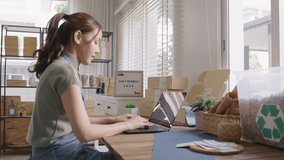 Save the planet earth Eco friendly box store in net zero waste shop asian seller digital retail working at home office. ESG Small SME owner woman asia people typing chat laptop on AI chatGPT chatbot. - Powered by Shutterstock - Get 15% off with code: PIKWIZARD15