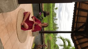 Young beautiful woman meditating and doing yoga in abandoned temple on Bali. Female practicing pose