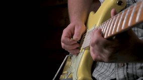 Man playing an yellow electric guitar. 4k video footage UHD 3840x2160
