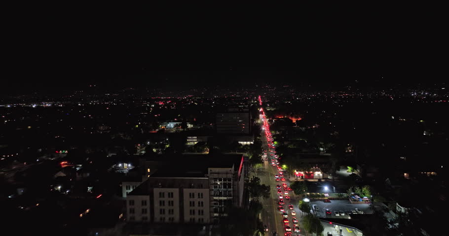 San Jose California Aerial v1 drone flyover east santa clara street from busy downtown across neighborhoods capturing heavy traffics at night - Shot with Mavic 3 Cine - June 2022