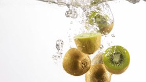 Sliced kiwi falling into water. Delicious kiwi fruit on white background with water bubbles and splashes. Concept of natural and organic food, nutrition, diet, vitamins. Space for ad - Powered by Shutterstock - Get 15% off with code: PIKWIZARD15