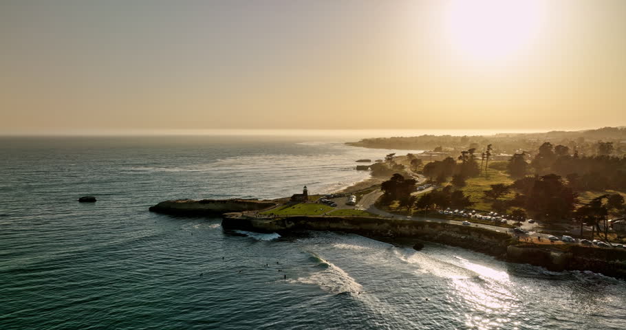 Santa Cruz California Aerial v2 fly around lighthouse point capturing traffics on west cliff drive and golden sunlight reflecting on the water surface at sunset - Shot with Mavic 3 Cine - May 2022 Royalty-Free Stock Footage #1108294147