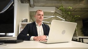 Caucasian deaf man talking sign language over video call on laptop in office. - Powered by Shutterstock - Get 15% off with code: PIKWIZARD15