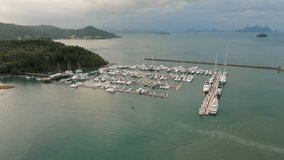 yachts and boats in marina bay at Phuket Thailand Aerial view video footage