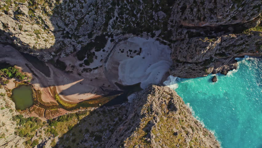 Sa Calobra Beach Between The Canyon Of Torrent de Pareis In Mallorca, Spain. aerial topdown