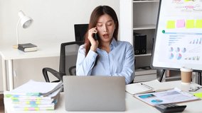 Asian woman sitting in startup company office, company employee talking on the phone with customer to make sales offer and special offer. Business communication concept. - Powered by Shutterstock - Get 15% off with code: PIKWIZARD15