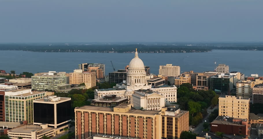 Flying backwards above Madison downtown buildings and the Wisconsin State Capitol