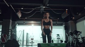 Asian woman jumping on plyo box for exercises at a fitness gym. Sports training, and fitness concepts. - Powered by Shutterstock - Get 15% off with code: PIKWIZARD15