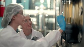 scientist woman worker checking and monitoring the control panel on machine system at the industrial factory. Female worker recording data at the control panel with measure pressure of water level. - Powered by Shutterstock - Get 15% off with code: PIKWIZARD15