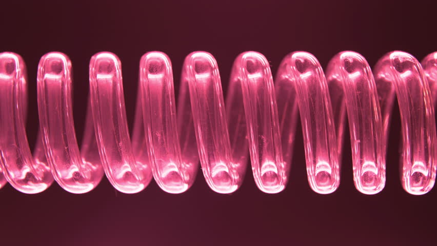 The flask and tube with a spiral inside. Chemical reactions. Energy. Motors. Red liquid flows in a spiral into the flask. Filtration process. Pink Neon. Dark Energy.