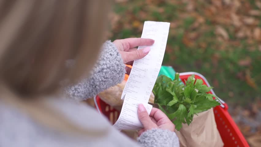 The buyer checks the paper receipt after shopping in the supermarket Royalty-Free Stock Footage #1108326501