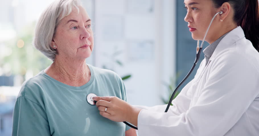 Doctor, elderly woman and breathe with stethoscope for listening to heartbeat, healthcare consultation and cardiology test in clinic. Medical worker, lungs and chest assessment of patient in hospital Royalty-Free Stock Footage #1108328665