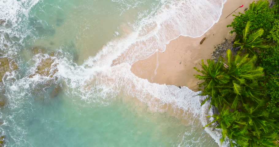 Top view island rock beach in the sea Sea wave come in beach rock Beautiful in nature ocean Andaman sea at rainy season Phuket Thailand. Filmed with high quality cinema cameras. DCI 4K ProRes422